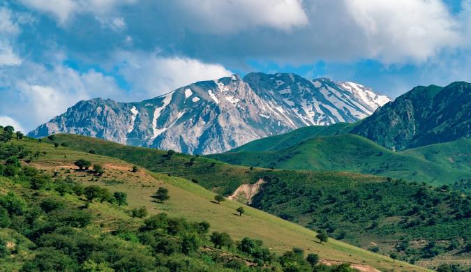 Hiking trail in Amirsoy mountain resort with lush green valleys.