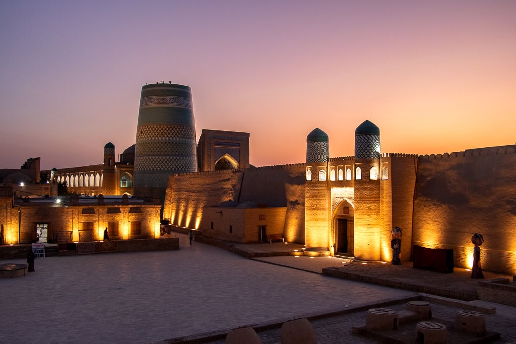Enjoy traditional Uzbek dinner with sunset views over Khiva landmarks