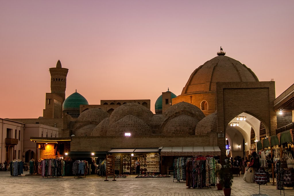 Walk through historic square surrounded by ancient Bukhara architecture