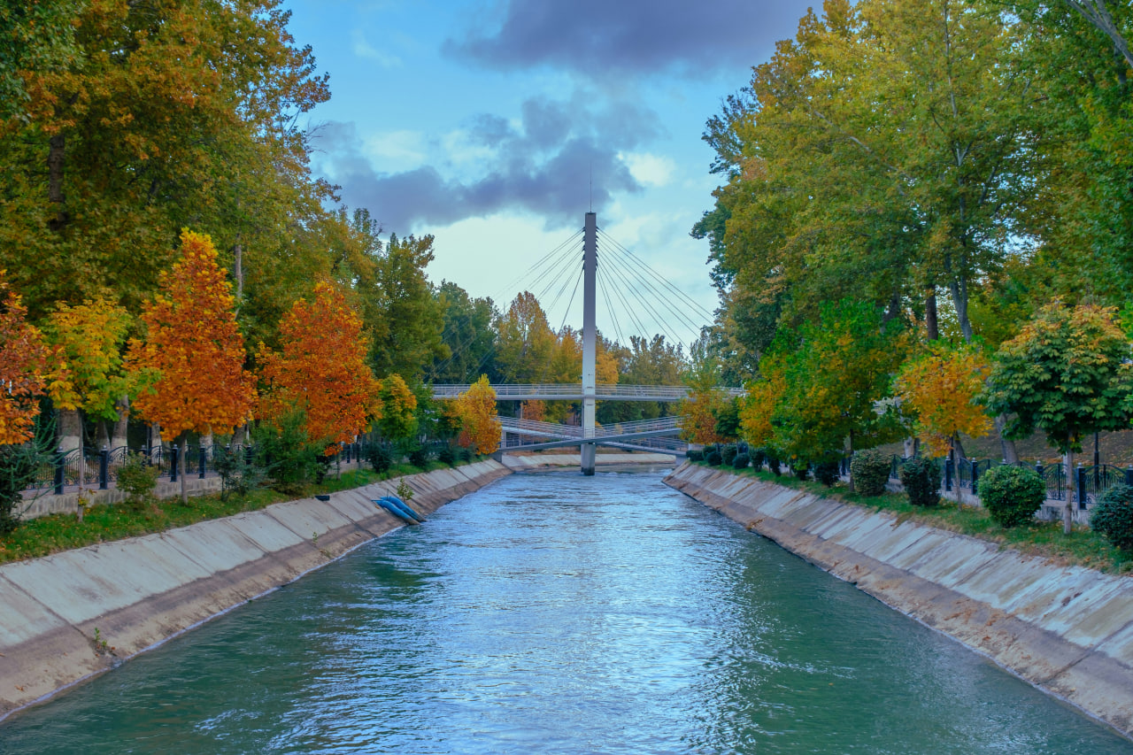 Stroll through Tashkent park with canal and bridge on tour